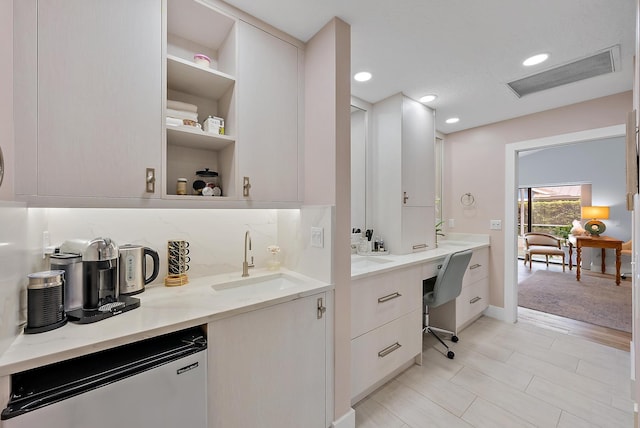 bathroom featuring vanity and tasteful backsplash