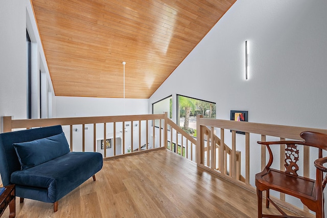 sitting room with high vaulted ceiling, wood ceiling, and light wood-type flooring