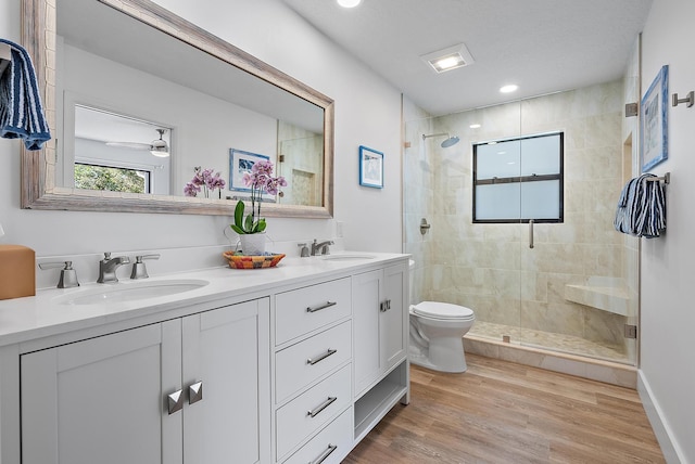 bathroom with vanity, wood-type flooring, an enclosed shower, and toilet