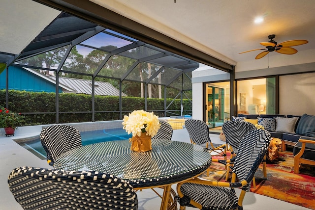 view of patio featuring ceiling fan and a lanai