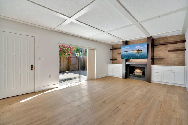 unfurnished living room featuring light wood-type flooring and coffered ceiling