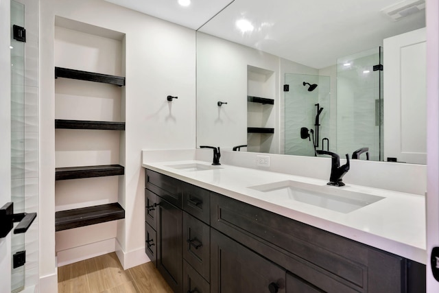 bathroom with vanity, wood-type flooring, and a shower with shower door