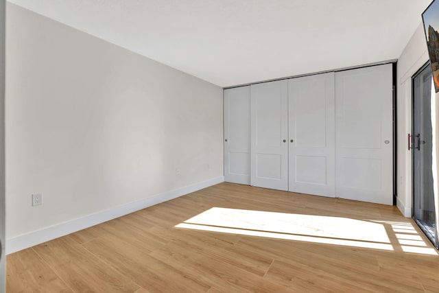 unfurnished bedroom featuring light wood-type flooring