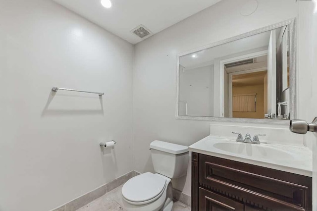 bathroom featuring tile patterned flooring, vanity, and toilet