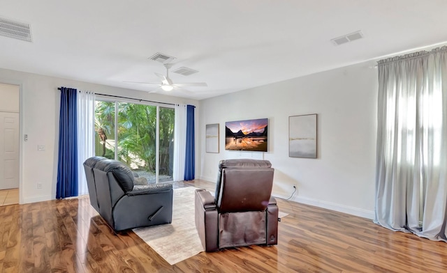 living room with hardwood / wood-style flooring and ceiling fan