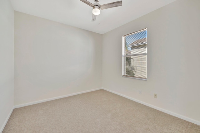 unfurnished room featuring light carpet, baseboards, and ceiling fan