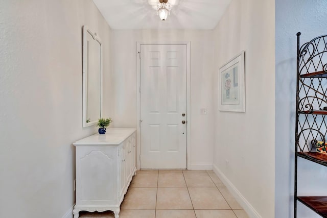 doorway with light tile patterned floors