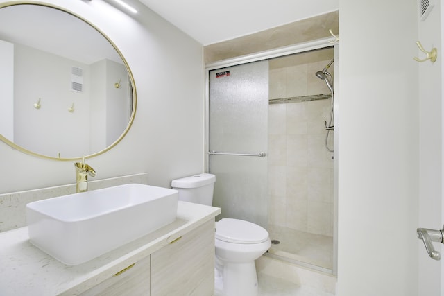 bathroom featuring toilet, an enclosed shower, and vanity