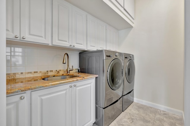 laundry room with cabinets, independent washer and dryer, sink, and light tile patterned floors