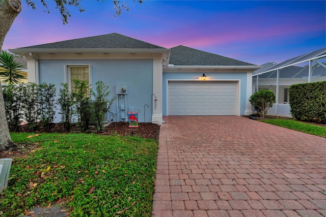 view of front of home featuring a garage and a lanai