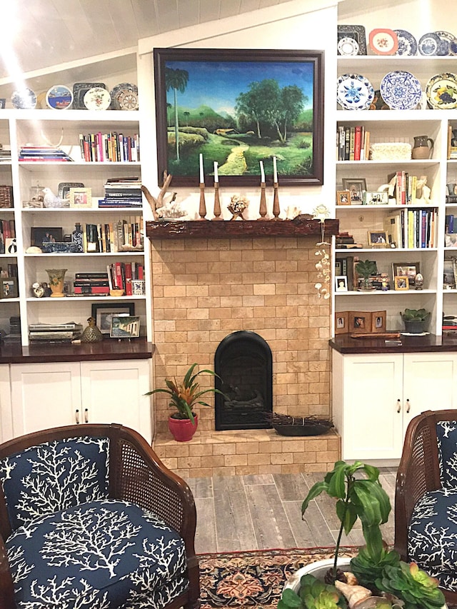 living room featuring a fireplace and vaulted ceiling