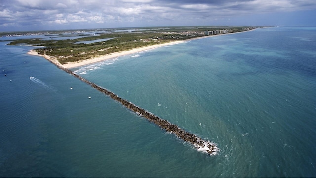 birds eye view of property featuring a water view and a view of the beach