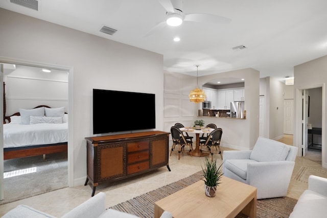 tiled living room featuring ceiling fan