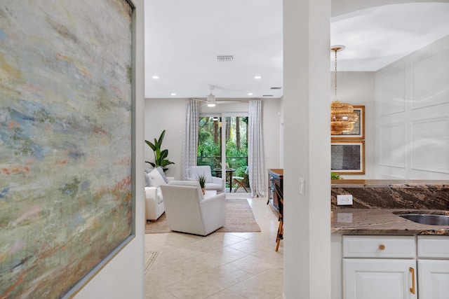 living room featuring light tile patterned floors and sink