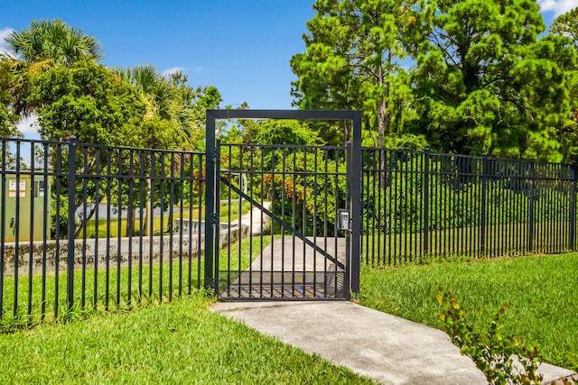 view of gate featuring a lawn