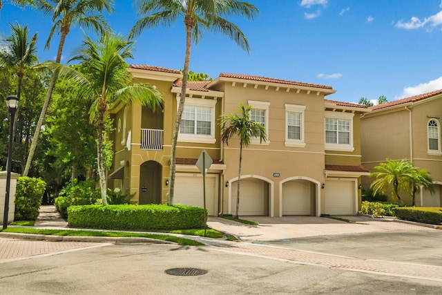 mediterranean / spanish-style house with a garage