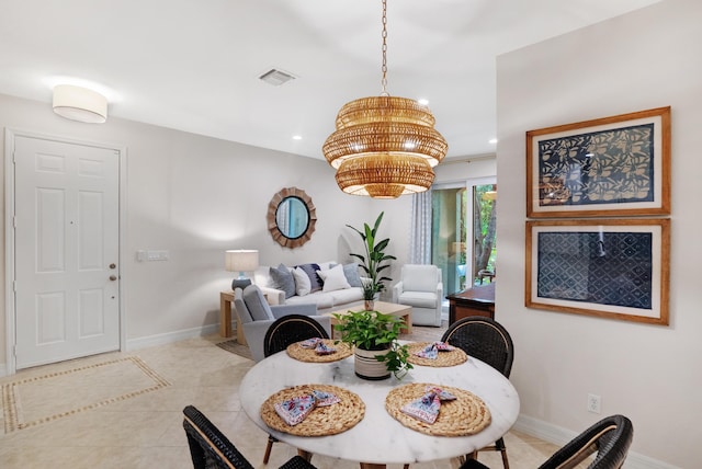 dining room with a chandelier and light tile patterned floors