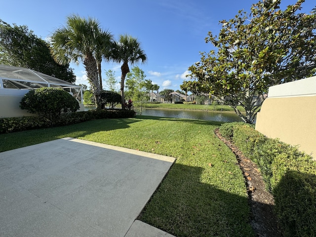 view of yard featuring a water view and a patio