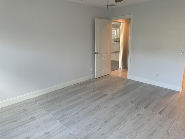 unfurnished room with ceiling fan