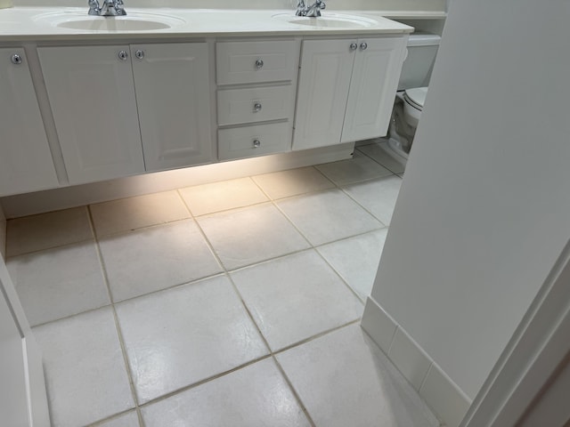 bathroom featuring tile patterned floors, vanity, and toilet