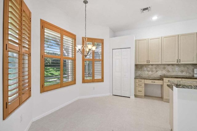 kitchen with a chandelier, pendant lighting, tasteful backsplash, and plenty of natural light