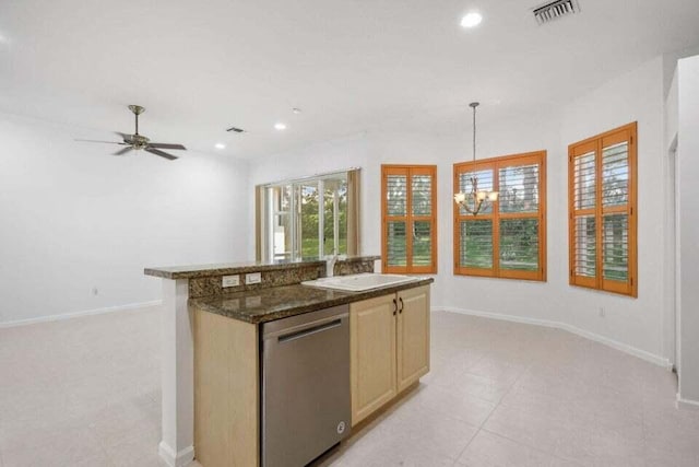 kitchen featuring pendant lighting, dishwasher, light brown cabinets, ceiling fan with notable chandelier, and dark stone countertops