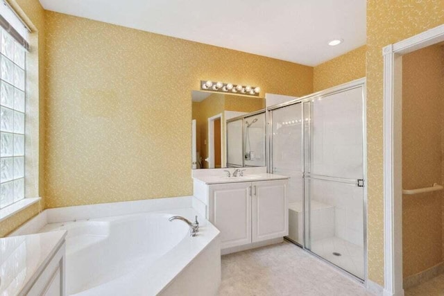 bathroom with vanity and separate shower and tub