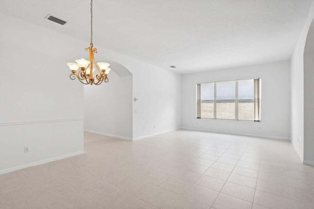 empty room with an inviting chandelier