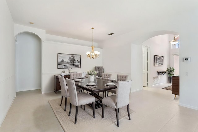 dining room featuring a chandelier and light tile patterned flooring