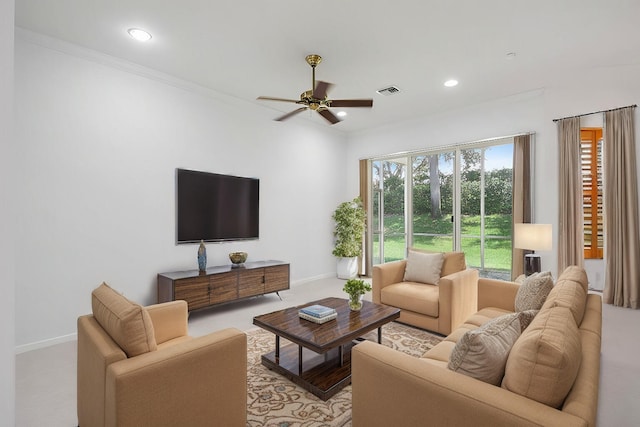 living room featuring ceiling fan and crown molding