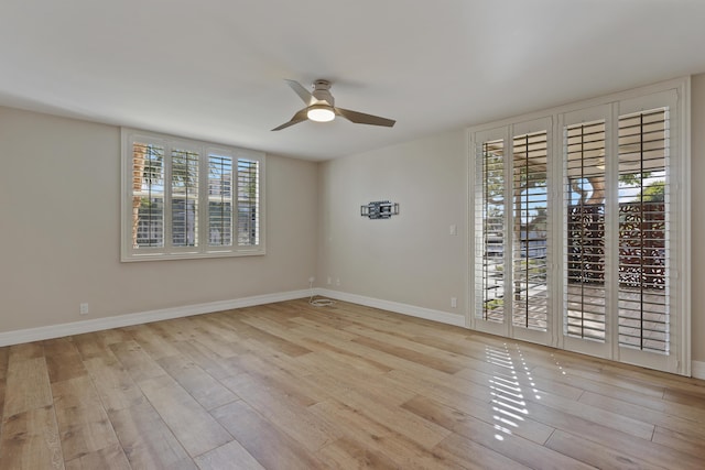 unfurnished room featuring ceiling fan, baseboards, and wood finished floors