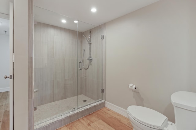 full bathroom with toilet, recessed lighting, wood finished floors, baseboards, and a shower stall