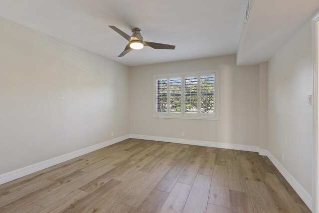 bathroom featuring hardwood / wood-style flooring, ceiling fan, toilet, and vanity