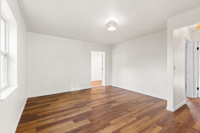 empty room with dark wood-type flooring