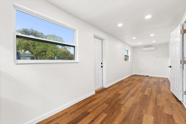 hall with dark hardwood / wood-style flooring and a wall mounted AC