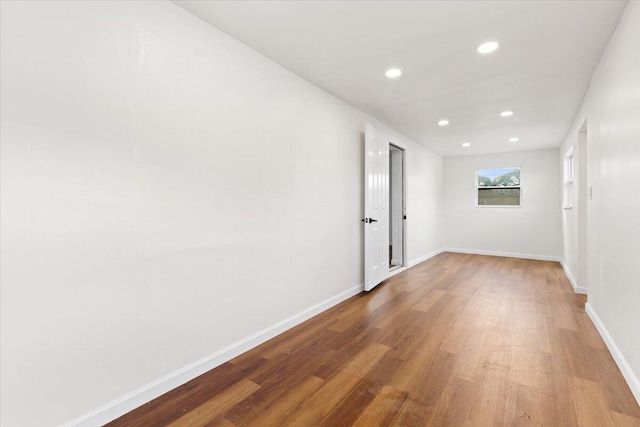 empty room with hardwood / wood-style floors