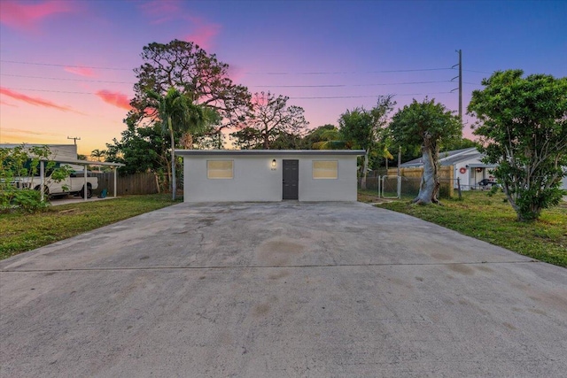 garage at dusk with a yard