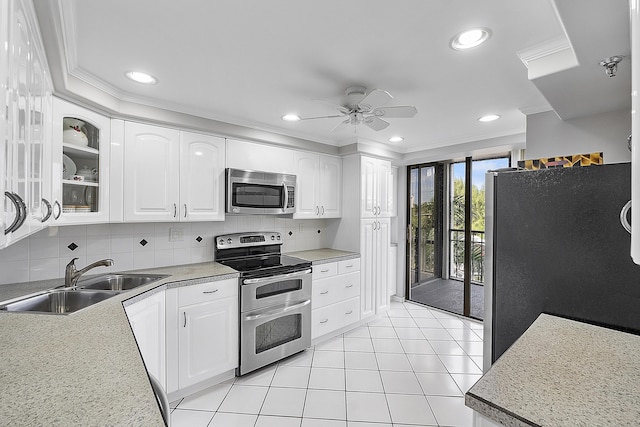 kitchen with white cabinets, sink, decorative backsplash, ceiling fan, and stainless steel appliances