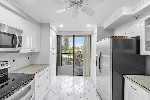 kitchen featuring stainless steel appliances, ceiling fan, crown molding, white cabinetry, and light tile patterned flooring