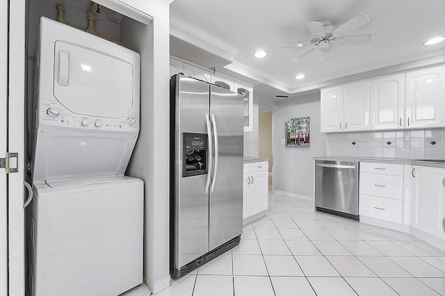 washroom with ceiling fan, ornamental molding, stacked washer and dryer, and light tile patterned floors