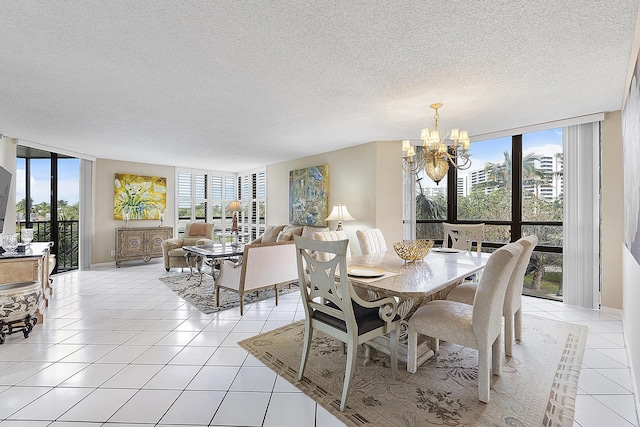 tiled dining room featuring a notable chandelier, floor to ceiling windows, and a textured ceiling