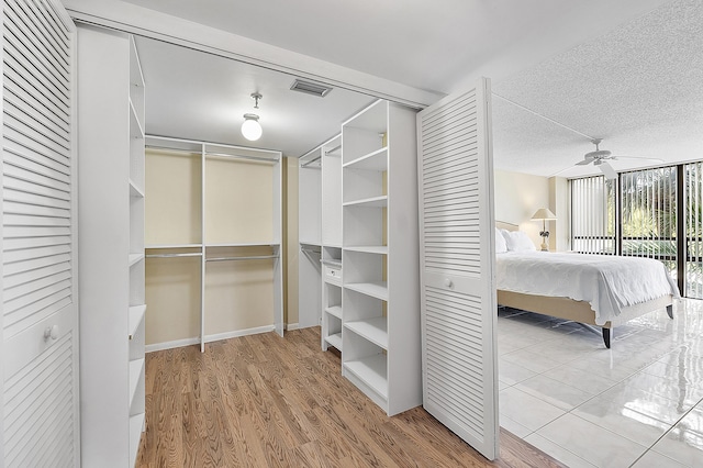 spacious closet with wood-type flooring and ceiling fan