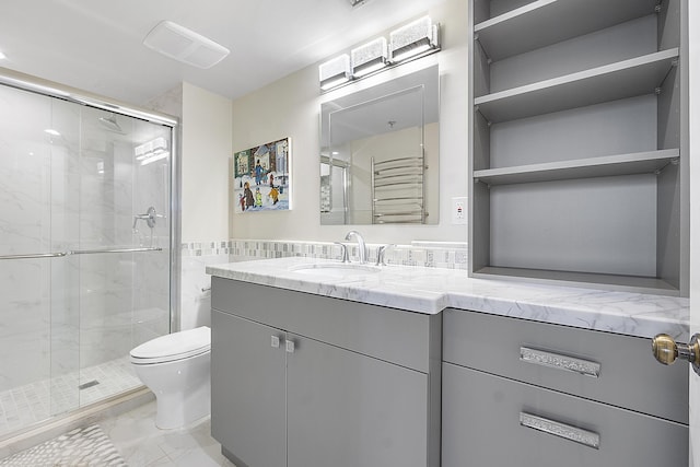 bathroom featuring vanity, toilet, and walk in shower