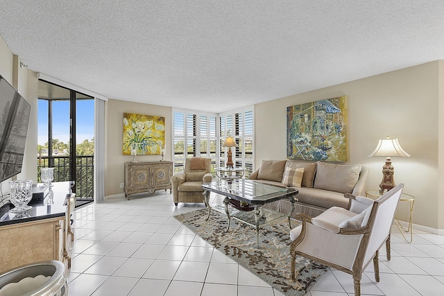 tiled living room featuring a wealth of natural light, a textured ceiling, and expansive windows