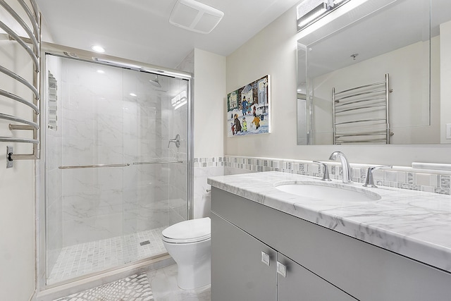 bathroom featuring walk in shower, radiator heating unit, vanity, and toilet