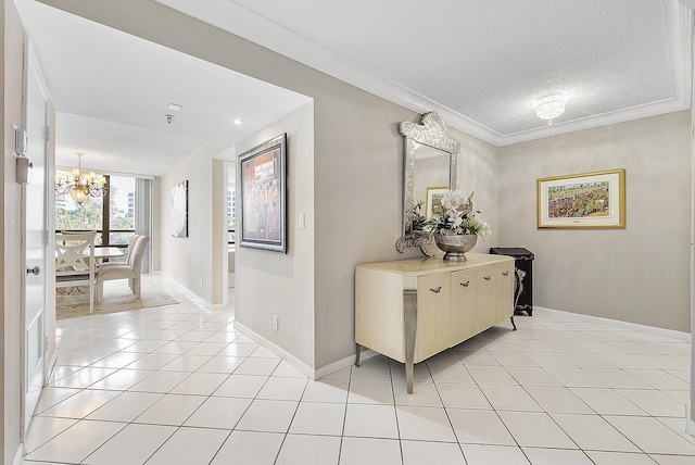 hall featuring light tile patterned flooring, crown molding, a textured ceiling, and a chandelier