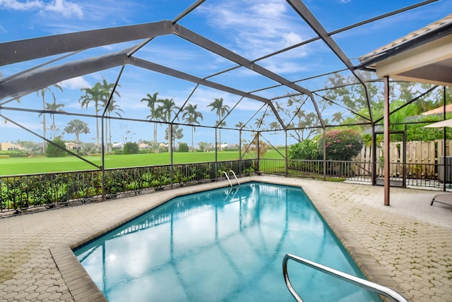 view of swimming pool with glass enclosure and a patio area