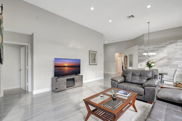 living room with a high ceiling and a chandelier