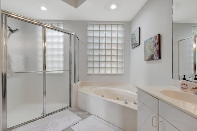 bathroom with vanity and independent shower and bath