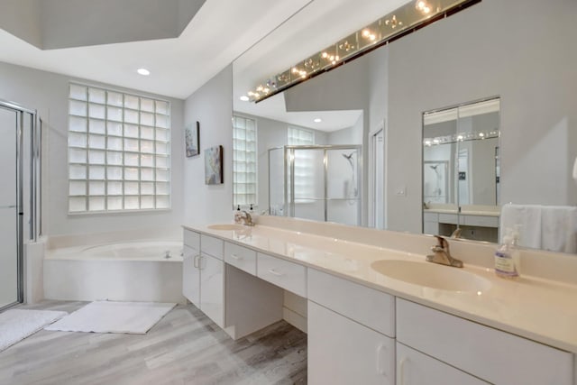 bathroom with vanity, plus walk in shower, and hardwood / wood-style flooring